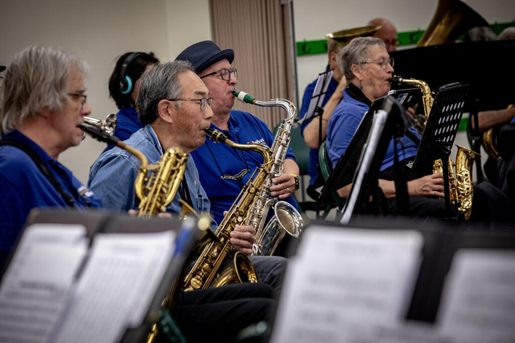 Three saxophone players rehearsing